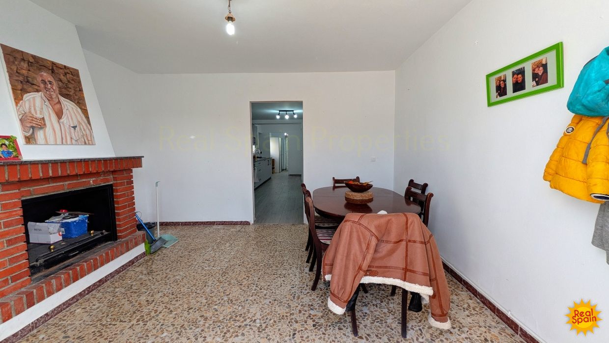 Dining area at Cortijo Salud with a fireplace and doorway to another room