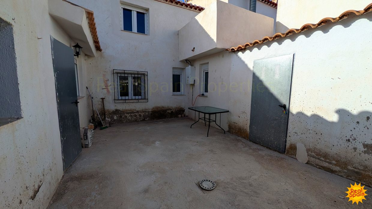 Patio area at Cortijo Salud with white exterior walls and outdoor table