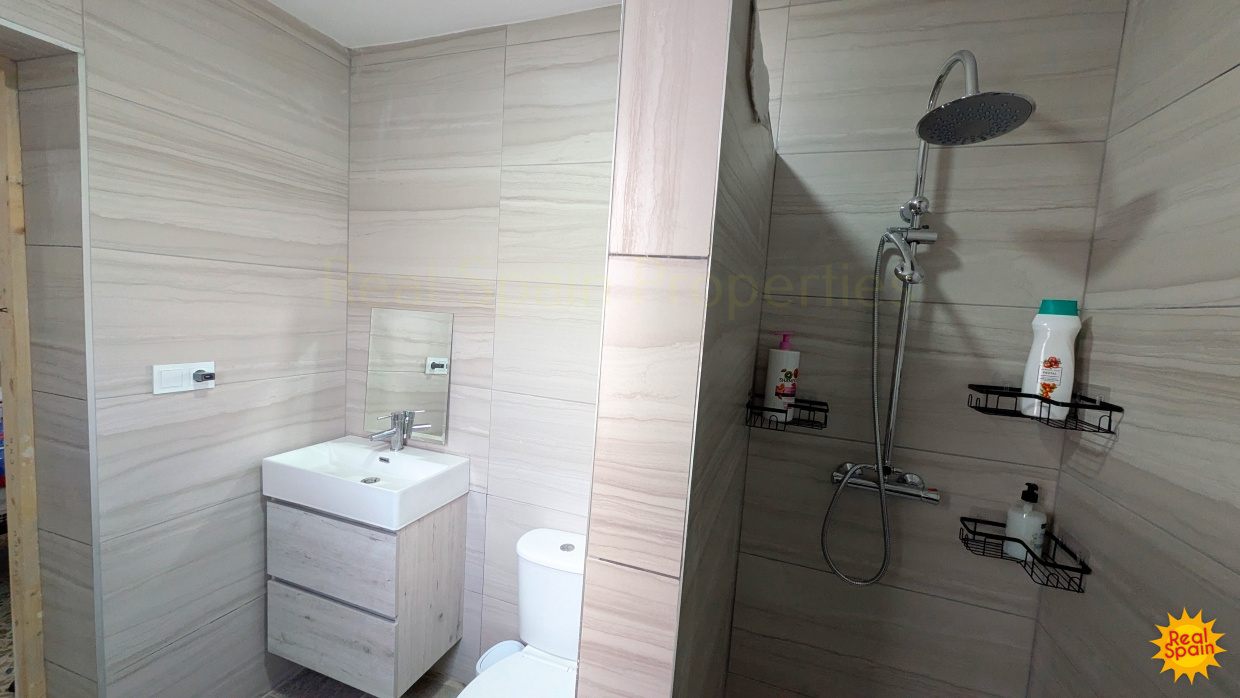 Shower room at Cortijo Salud with basin, toilet and tiled shower area